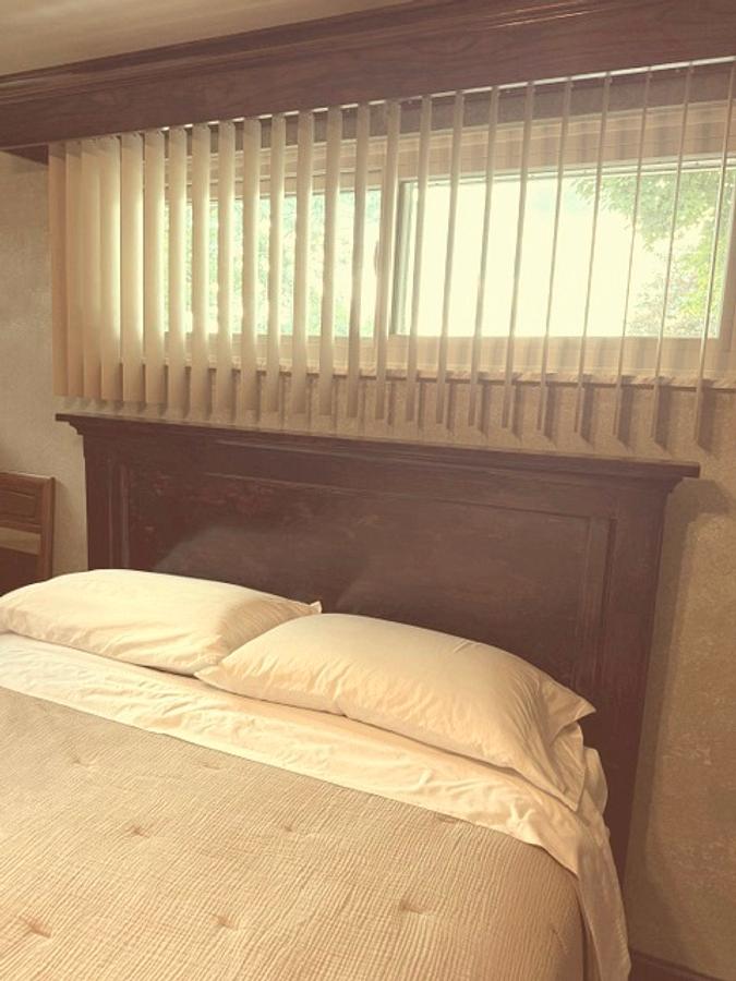 Headboard, with weathered and worn appearance. 