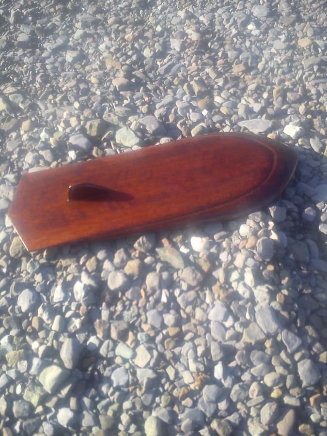 small wooden bodysurf handplane