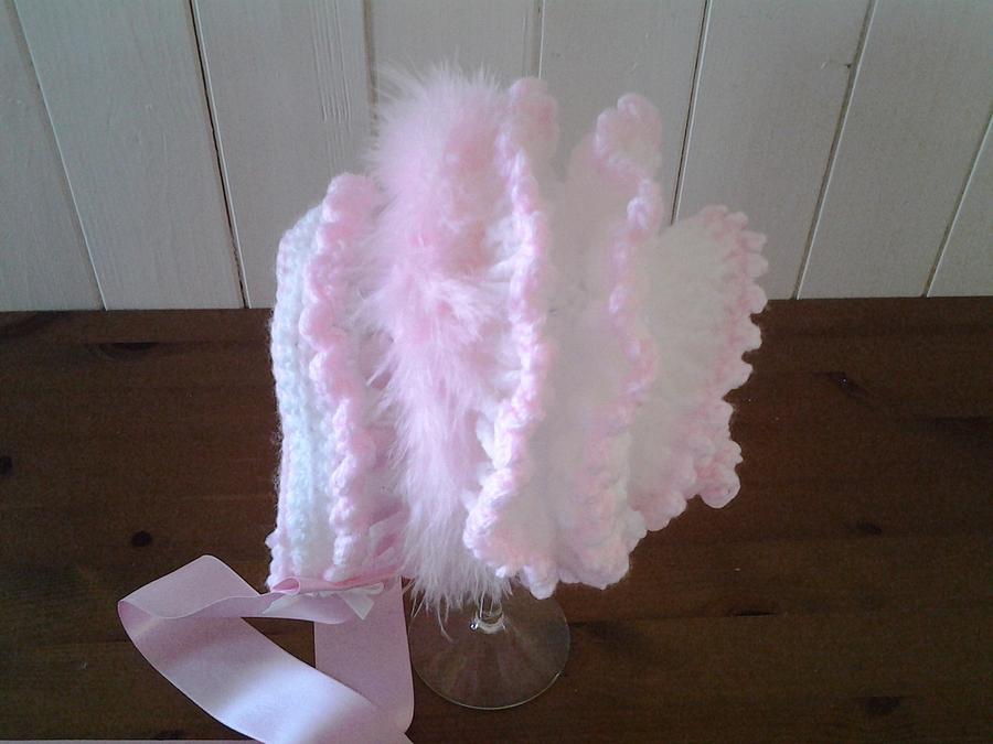 White and pink frilled baby bonnet