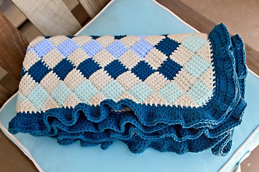 Peacock blue, teal, light blue, and beige entrelac baby blanket