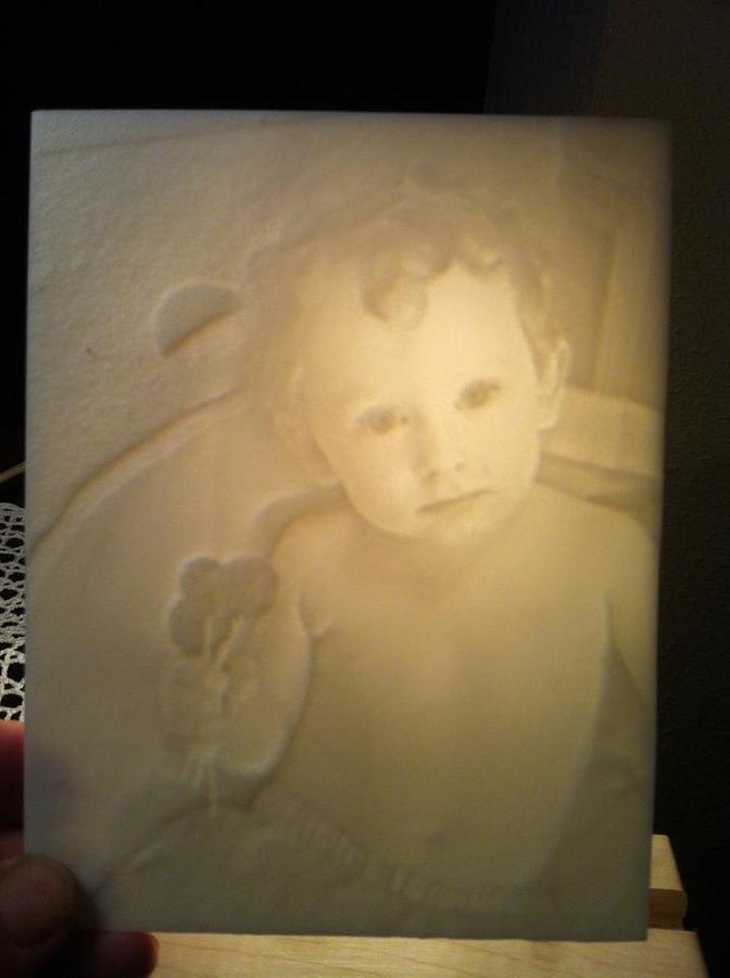 Lithophanes.  Photos carved into Corian