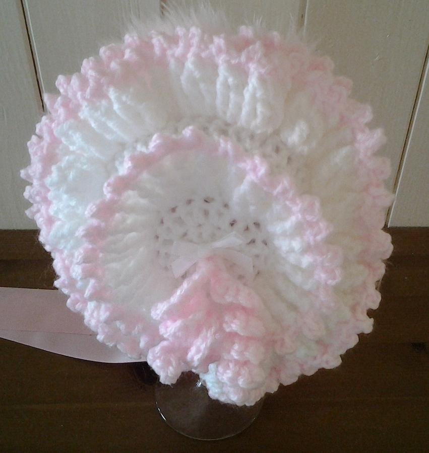 White and pink frilled baby bonnet