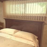 Headboard, with weathered and worn appearance. 