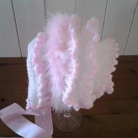 White and pink frilled baby bonnet