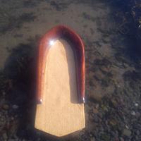 small wooden bodysurf handplane