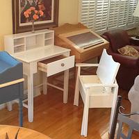 White writing desk with chair, storage in bottom of chair.