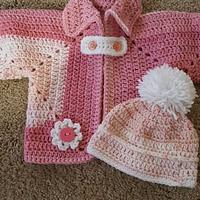 Three little sweaters with beanies