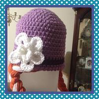 Purple hat with red braided pigtails