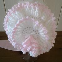 White and pink frilled baby bonnet