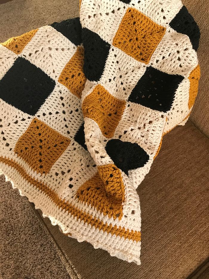 Crocheted solid granny square lap throw