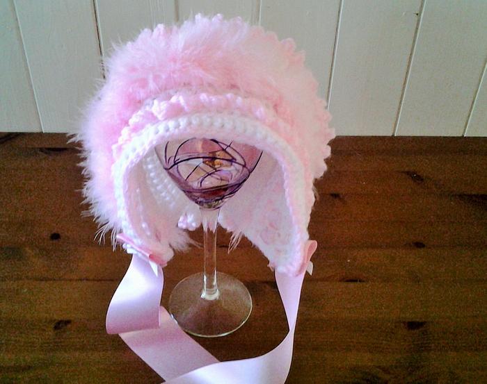 White and pink frilled baby bonnet