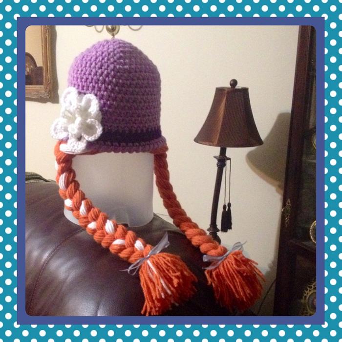 Purple hat with red braided pigtails